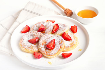 Homemade pancakes with cottage cheese and strawberry slices