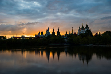 Fototapeta na wymiar View Of The Kremlin Izmailovo Through A Silver-Grape Pond At Sunset