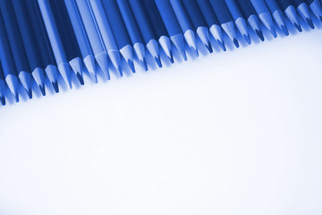 Pencils in classic blue tinted color of the year. A lot of colored pencils on a white background.