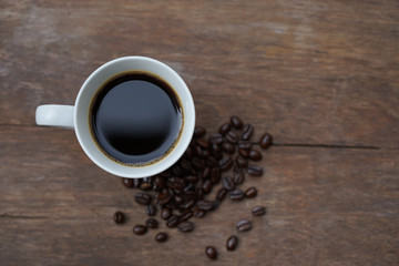 Top view black coffee with seeds loneliness in the morning breakfast vintage style on wood table  
