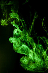 Green smoke motion on black background.