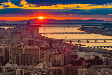 Japan. Osaka. Sunset on the Bay of Osaka. Evening panorama of Osaka from a height. island of Honshu. The urban landscape of Japan. Urbanistics. Modern buildings in Japan. Bridges over the Yodo river.