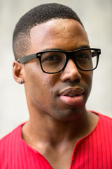 Obraz premium Face of young handsome African man with eyeglasses