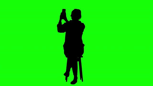 Woman Sends a Selfie Photo While Sitting Green Screen Silhouette