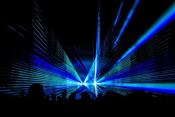 Blue laser show nightlife club stage with party people crowd. Luxury entertainment with audience...