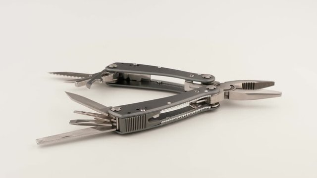 Multitool on a white background closeup.