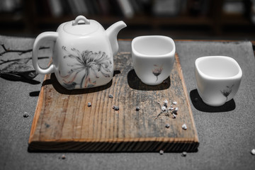 White ceramic tea set. Tea ware for traditional tea ceremony. Teapot and cups with flower pattern