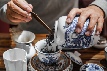 Obraz na płótnie Canvas Traditional tea ceremony. Chinese tea. Man brews tea.