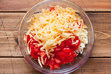 Step-by-step preparation of salad with crab sticks, tomatoes, cheese and eggs, step 4- adding grated cheese, top view, selective focus © Анна Журавлева