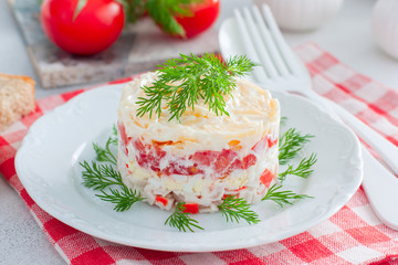 Homemade salad with crab sticks, tomatoes, cheese on a white dish, horizontal