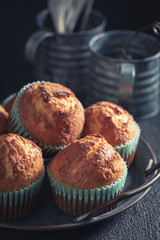 Closeup of vanilla cupcakes on old metal plate