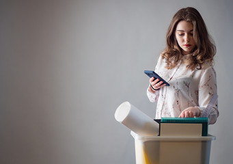 Fototapeta premium Job loss. A girl who got fired from her job. Loss of jobs. The girl is sad because of the dismissal. Unemployment.