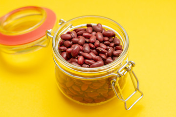 Red beans in a glass jar on a yebackground