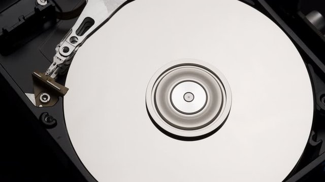 Macro, Close-Up of Computer Hard Disk Drive Spinning and Writing. 4k