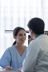 A doctor take care of sick patient woman at the hospital or medical clinic.