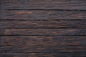 The texture of natural wood real processed for background. Copy space, banner. Dark brown wood