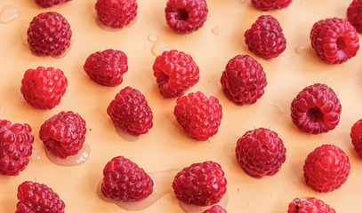 Red raspberries on a yellow background