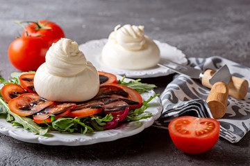 Salad with arugula, tomatoes and Italian burrata cheese