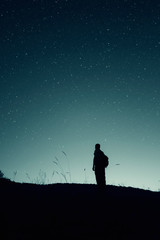 stars on the night sky and man silhouette star gazing, night landscape