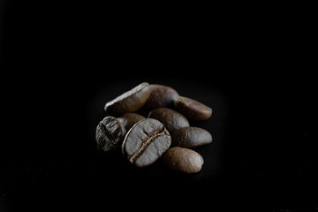 roasted coffee beans on a black background