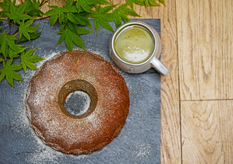 Top view of Bundt cake and match latte cup. 