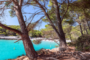 Obraz premium View of the famous beach Cala Turqueta. (Focus on foreground, people on the beach in blur). Menorca, Balearic islands, Spain