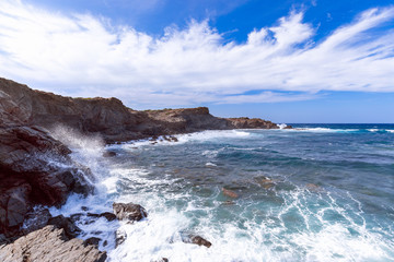Fototapeta na wymiar Beautiful view of a rocky bay with waves on the sea on the island of Menorca, Balearic islands, Spain