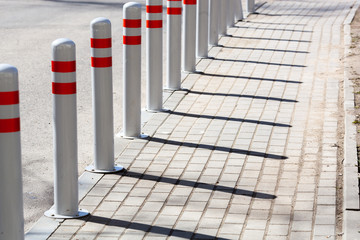 A barrier made of plastic columns with reflective pigment on an asphalt road. Danger concept