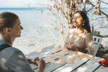 Woman is reading Tarot cards with a customer outdoors