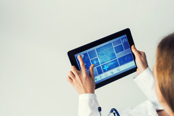 Close of female doctor hands working with tablet pc computer