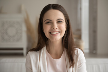 Headshot portrait of smiling millennial girl look at camera have webcam conference at home, happy young Caucasian woman speak talk on video call, engaged in web conversation using modern technology