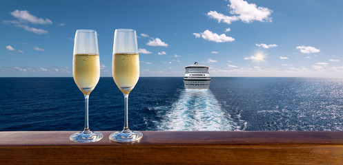 Luxury cruise travel with glasses of champagne on wooden railing. 