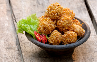 crispy noodle balls served on bowl, also known as bola bola mie