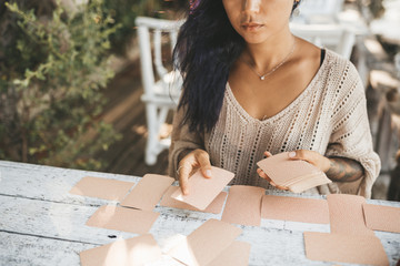Close uo of female hands with Tarot cards