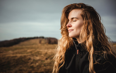 Happy young woman with long hair lifestyle portrait outdoor