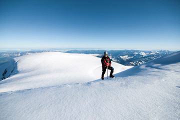 Fototapeta na wymiar climber in a red jacket climbs a mountain