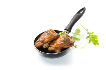 chicken legs fried in oil in a pan