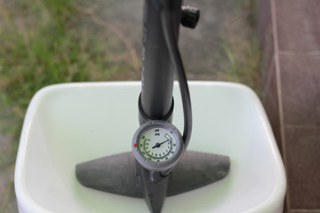 close up Manual air pump with barometer on blur background