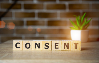 Consent - word from wooden blocks with letters, sexual education age of consent concept, top view...