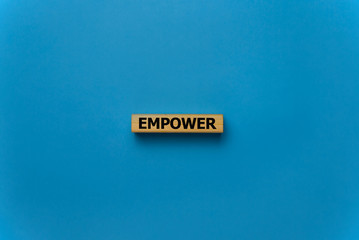 EMPOWER word written on wood block, business concept