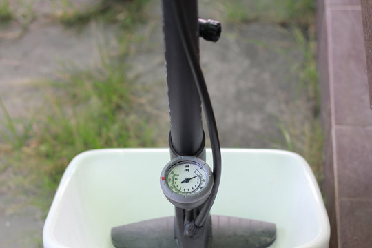 close up Manual air pump with barometer on blur background