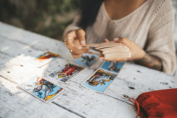 Close uo of female hands with Tarot cards