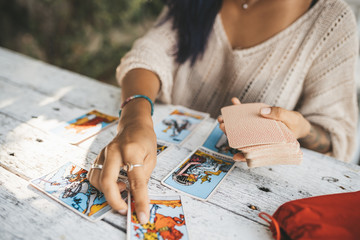 Close uo of female hands with Tarot cards