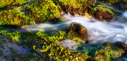 Naklejka na ściany i meble Long exposures of moving waters and waterfalls of the coral shoreline f Oahu Hawaii The seas moving dancing water