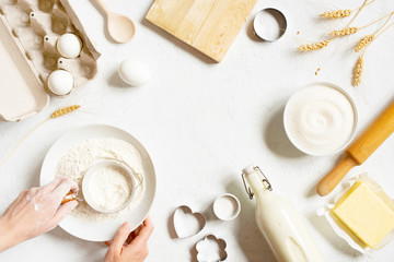 Background with ingredients for home baking decorated with wheat ears