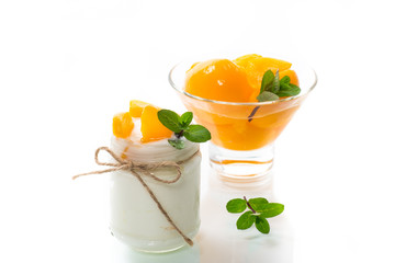 homemade sweet yogurt with slices of pickled peaches in a glass jar