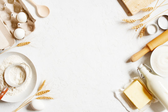 Background with ingredients for home baking decorated with wheat ears