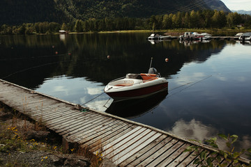 Fototapeta premium boats in pristan on a mountain river in norway