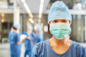 Young anesthetist with surgical mask and hood