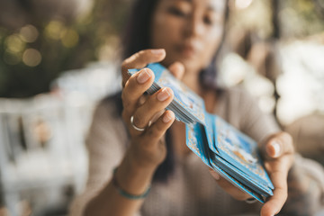Close uo of female hands with Tarot cards